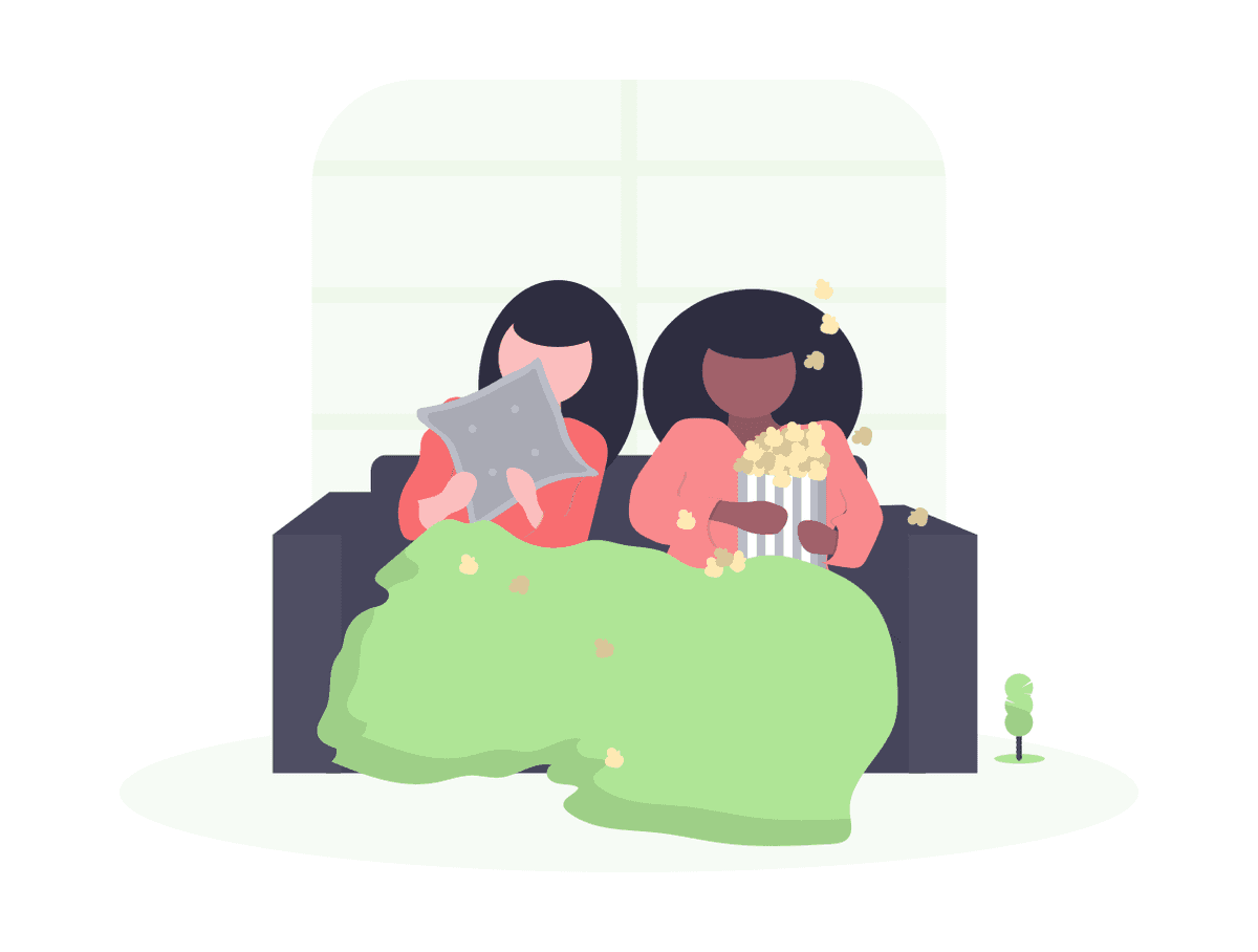 Two individuals sitting in a cozy couch with a blanket while eating popcorn.